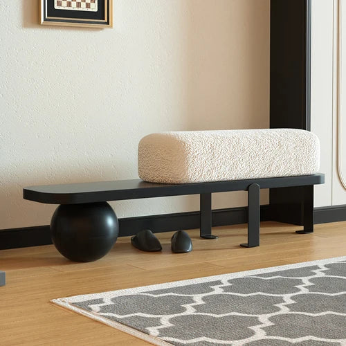 A simple and luxurious long bench at the entrance of a household, with a wooden color at the end of the bed