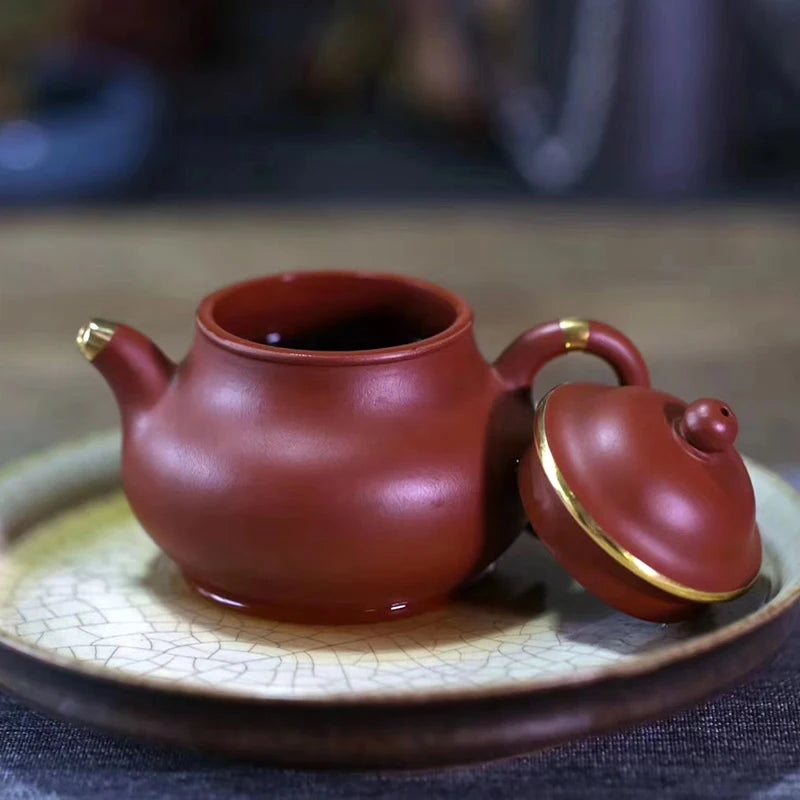 Yishuitang Yixing raw ore pure handmade purple clay pot family small coal mine vermilion clay pot bag 24K gold 180ml