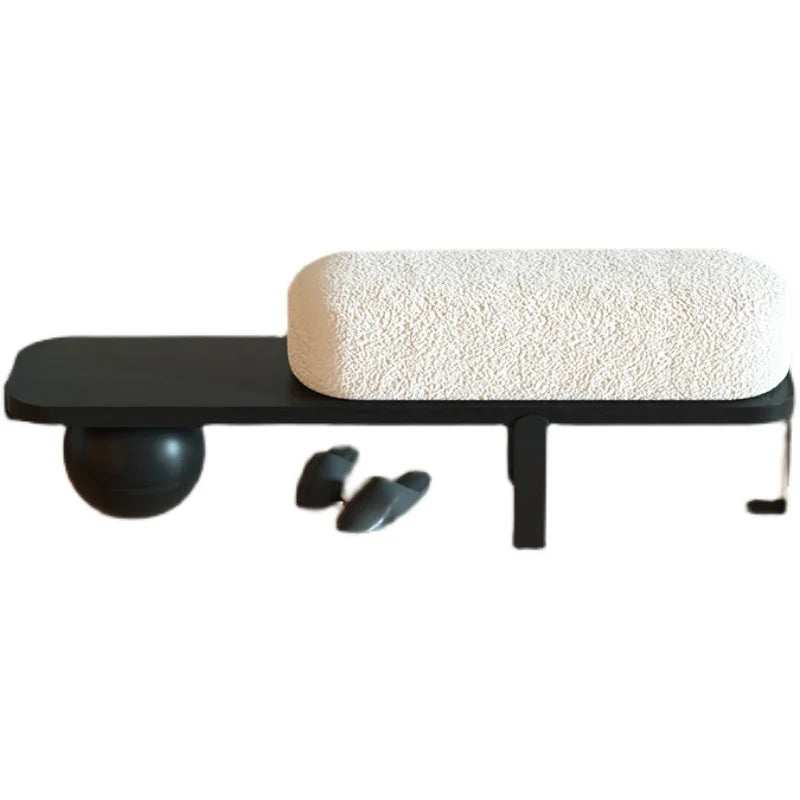A simple and luxurious long bench at the entrance of a household, with a wooden color at the end of the bed