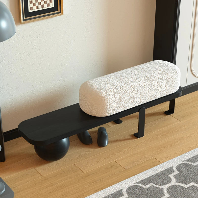 A simple and luxurious long bench at the entrance of a household, with a wooden color at the end of the bed
