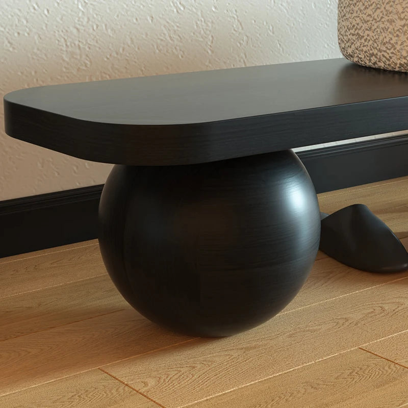 A simple and luxurious long bench at the entrance of a household, with a wooden color at the end of the bed